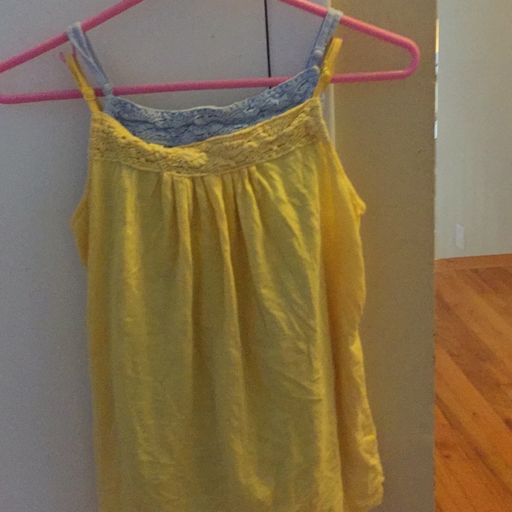 A yellow and blue, lacy, stretchy tank top.